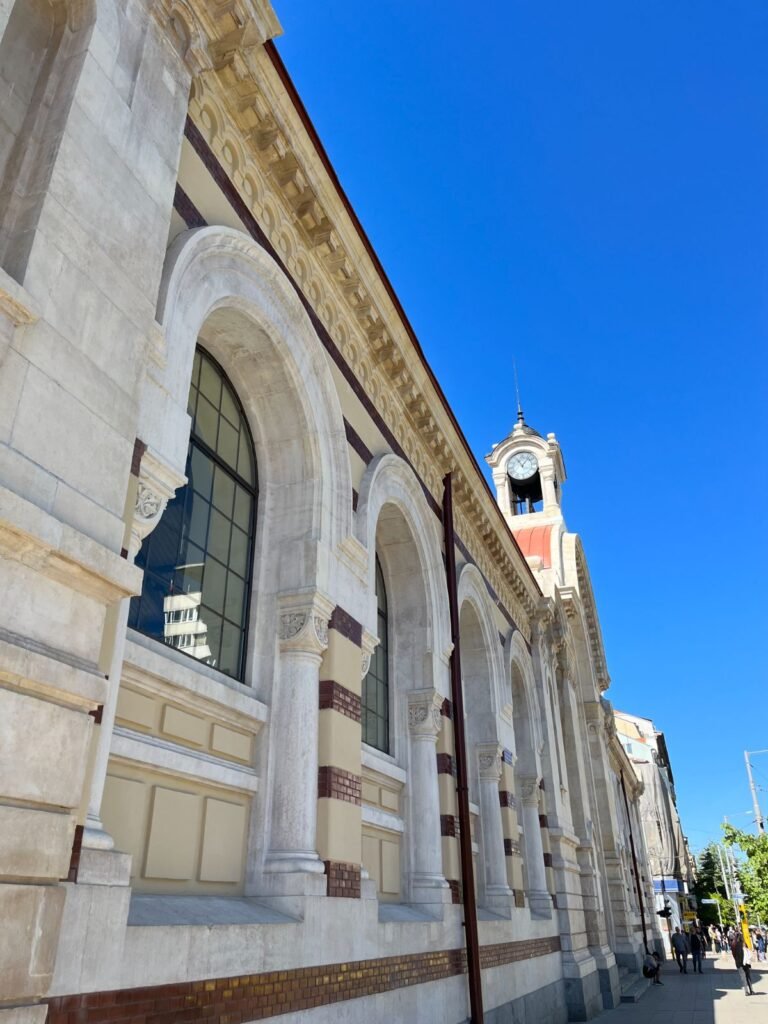 Clock tower and arched facade of the Central Market Hall in Sofia